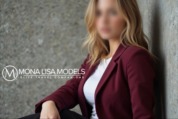 Chantelle sitting in the corner, wearing a burgandy blazer 