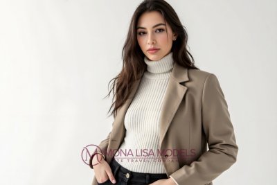 Elite Melbourne escort - elegant brunette model posing confidently at the camera, wearing a tailored blazer, exuding sophistication and poise.